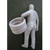 1:24 - Mechanic carrying tires